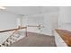 Bright landing featuring white walls, wooden banister and trim, and neutral carpeting at 125 Cove Creek Loop # 18, Mooresville, NC 28117