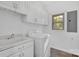 Bright laundry room features a sink, washer, dryer, cabinets and a window at 125 Cove Creek Loop # 18, Mooresville, NC 28117