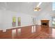 Spacious living room with a fireplace, hardwood floors, and access to the outdoor deck at 125 Cove Creek Loop # 18, Mooresville, NC 28117