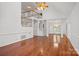 Bright living room featuring hardwood floors, a vaulted ceiling, and a staircase to the second floor at 125 Cove Creek Loop # 18, Mooresville, NC 28117
