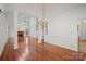 Open-concept living space with hardwood floors, a fireplace, and plenty of natural light at 125 Cove Creek Loop # 18, Mooresville, NC 28117