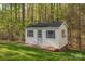Backyard outbuilding shed with shuttered windows, full door, and painted siding at 125 Cove Creek Loop # 18, Mooresville, NC 28117