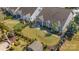 Aerial view of a well-maintained backyard with lush lawn, patio, garden with a small shed, and black aluminum fence at 13311 Union Square Dr, Huntersville, NC 28078