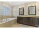 This bathroom features double sinks, granite countertop, soaking tub, and tile flooring at 13311 Union Square Dr, Huntersville, NC 28078