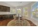 Bright dining area featuring dark cabinetry and an abundance of natural light at 13311 Union Square Dr, Huntersville, NC 28078