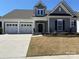 Charming home featuring a three-car garage, manicured lawn and inviting front entrance at 13311 Union Square Dr, Huntersville, NC 28078