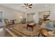 Open living area featuring hardwood floors, neutral paint, and bright dining room at 13311 Union Square Dr, Huntersville, NC 28078