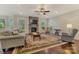 Open living room with hardwood floors, stone fireplace, and windows for natural light at 13311 Union Square Dr, Huntersville, NC 28078