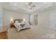 Main bedroom boasting tray ceiling, neutral paint, plush carpet and natural light at 13311 Union Square Dr, Huntersville, NC 28078