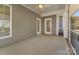Covered porch with ceiling fan and gray siding at 13311 Union Square Dr, Huntersville, NC 28078