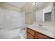 Cozy bathroom featuring a tub-shower combo, wood vanity and ample lighting at 13376 Calloway Glen Dr, Charlotte, NC 28273