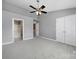 Neutral carpet bedroom featuring a walk-in closet and private bathroom at 13376 Calloway Glen Dr, Charlotte, NC 28273