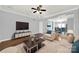 Bright living room featuring hardwood floors, a ceiling fan, and an open floor plan at 13376 Calloway Glen Dr, Charlotte, NC 28273