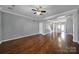 Inviting living area showcasing hardwood floors, crown molding, and an open layout to the kitchen at 13376 Calloway Glen Dr, Charlotte, NC 28273