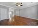Hardwood floored living room featuring an open concept layout connecting to the adjacent kitchen at 13376 Calloway Glen Dr, Charlotte, NC 28273