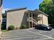 Inviting condo exterior with stairs to entrance, car parking, and attractive landscaping at 140 Lake Concord Ne Rd # D-1, Concord, NC 28025