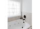 Close up of a luxurious soaking tub with black faucet fixture and decorative leaded glass window at 1643 Mayfair Dr, Conover, NC 28613