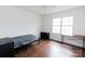This simple bedroom features hardwood floors, natural light, a ceiling fan and furniture at 1643 Mayfair Dr, Conover, NC 28613