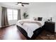 Bright bedroom features wood floors, neutral walls, large windows, and a modern ceiling fan at 1643 Mayfair Dr, Conover, NC 28613