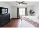 This spacious bedroom features hardwood floors, a ceiling fan, and a large window for plenty of natural light at 1643 Mayfair Dr, Conover, NC 28613