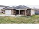 Charming brick home featuring a well-maintained lawn and a cozy front porch with seating at 1643 Mayfair Dr, Conover, NC 28613