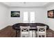 Spacious game room with a poker table, four chairs and an exit to the backyard at 1643 Mayfair Dr, Conover, NC 28613