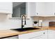 Close-up of kitchen sink, butcher block countertops and modern black fixtures at 1643 Mayfair Dr, Conover, NC 28613