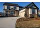 Charming two-story home featuring a stone facade, covered porch, and attached two-car garage at 1939 Hendricks St, Rock Hill, SC 29732