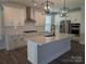 Modern kitchen featuring white cabinets, a center island, stainless steel appliances and stylish lighting at 1939 Hendricks St, Rock Hill, SC 29732