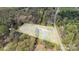 Aerial view of a property with bordered property lines, a house, and a barn surrounded by lush greenery at 1975 Old Wilkesboro Rd, Taylorsville, NC 28681