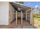 A covered animal pen featuring sturdy wooden posts and a secure metal gate, ideal for livestock at 1975 Old Wilkesboro Rd, Taylorsville, NC 28681