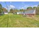 Spacious backyard featuring lush lawn and metal garden beds at 1975 Old Wilkesboro Rd, Taylorsville, NC 28681