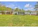 Spacious backyard featuring a well-maintained lawn, a covered patio and a single-story home with brick accents at 1975 Old Wilkesboro Rd, Taylorsville, NC 28681