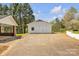 White barn with double doors and adjacent covered structure situated on a paved lot, surrounded by lush greenery at 1975 Old Wilkesboro Rd, Taylorsville, NC 28681