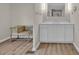 Bright bathroom featuring a vanity with double mirrors, wood floors, and a decorative seat at 1975 Old Wilkesboro Rd, Taylorsville, NC 28681