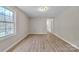 Well-lit bedroom featuring wood floors, natural light, and access to an attached bathroom at 1975 Old Wilkesboro Rd, Taylorsville, NC 28681