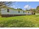 The house has a well-maintained lawn and multiple windows that provide ample natural light into the home at 1975 Old Wilkesboro Rd, Taylorsville, NC 28681