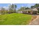 Expansive green lawn surrounding a single-story home with brick and white accents and covered front porch at 1975 Old Wilkesboro Rd, Taylorsville, NC 28681