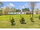 Charming single-story home with a brick accent, surrounded by a lush green lawn and a delicate metal fence at 1975 Old Wilkesboro Rd, Taylorsville, NC 28681