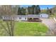 Charming single-story home with a carport and spacious lawn, set in a tranquil, tree-filled location at 1975 Old Wilkesboro Rd, Taylorsville, NC 28681