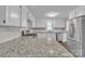 This kitchen features white cabinets, granite countertops, stainless steel appliances and a modern gas range at 1975 Old Wilkesboro Rd, Taylorsville, NC 28681
