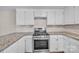 Bright kitchen features white cabinets, granite counters, stainless steel range, and subway tile backsplash at 1975 Old Wilkesboro Rd, Taylorsville, NC 28681
