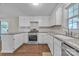Modern kitchen features white cabinets, granite countertops and stainless steel appliances with a window above the sink at 1975 Old Wilkesboro Rd, Taylorsville, NC 28681