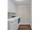 Laundry room with white washer and dryer, neutral walls, and hardwood floors at 1975 Old Wilkesboro Rd, Taylorsville, NC 28681