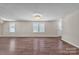 A bright and airy living room with gleaming hardwood floors, neutral walls and large windows to let light in at 1975 Old Wilkesboro Rd, Taylorsville, NC 28681