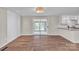 Open living space with hardwood floors, access to kitchen and outdoor views through sliding glass doors at 1975 Old Wilkesboro Rd, Taylorsville, NC 28681