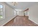 A spacious living room with hardwood floors, neutral walls, decorative lighting fixture and large windows at 1975 Old Wilkesboro Rd, Taylorsville, NC 28681