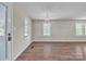 An airy living room with hardwood floors, neutral walls, decorative lighting fixture and large windows at 1975 Old Wilkesboro Rd, Taylorsville, NC 28681