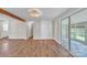 Living room featuring wood floors, neutral paint, beamed accent, and sliding glass doors to backyard at 1975 Old Wilkesboro Rd, Taylorsville, NC 28681
