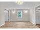 Spacious main bedroom featuring wood floors, natural light, an ensuite bathroom, and wall-mounted sconces at 1975 Old Wilkesboro Rd, Taylorsville, NC 28681